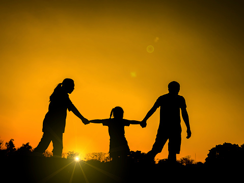 silhouette father, mother and daughter